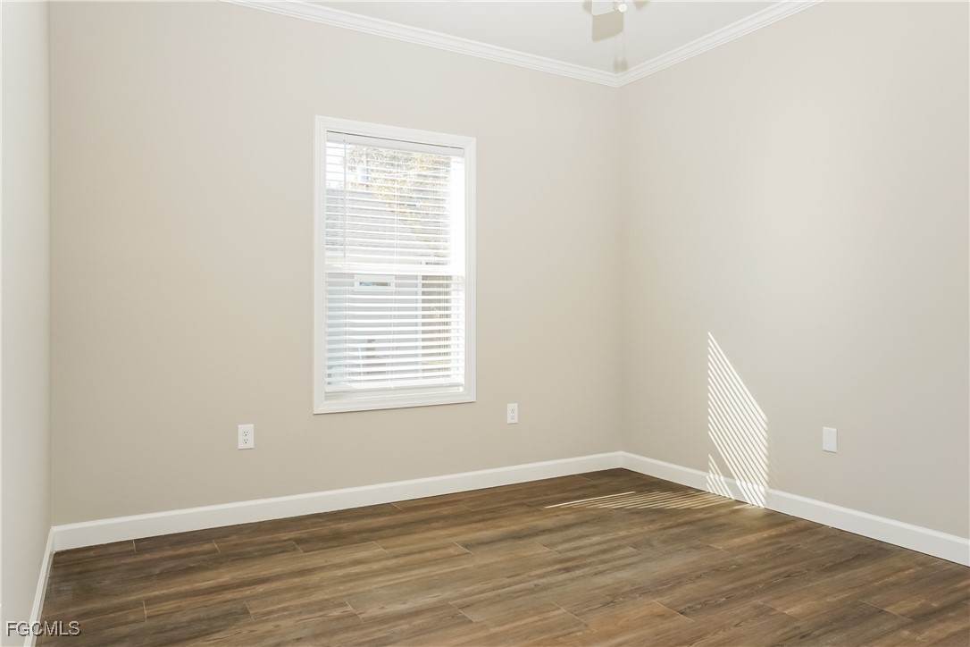 12315 Tangier Street North Port, FL 34287 - Photo 12 of 16 an empty room with wooden floor and windows