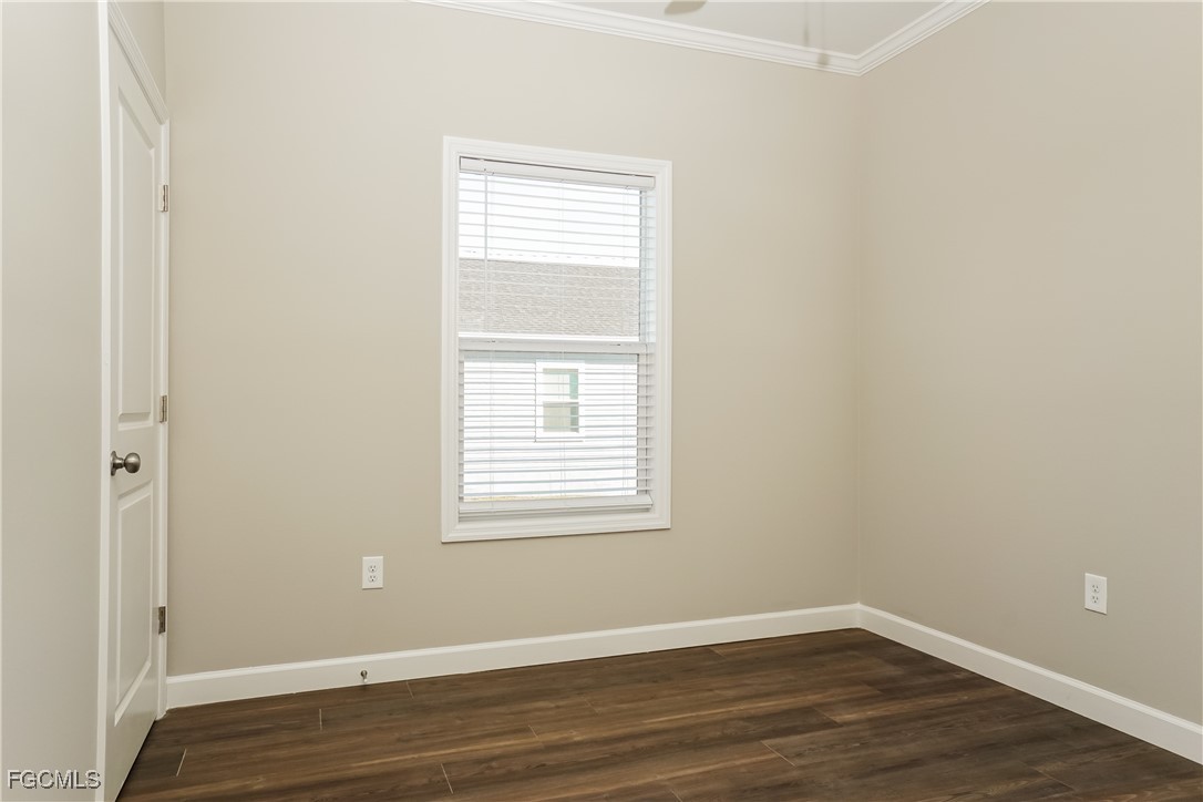 12315 Tangier Street North Port, FL 34287 - Photo 13 of 16 an empty room with wooden floor and a window
