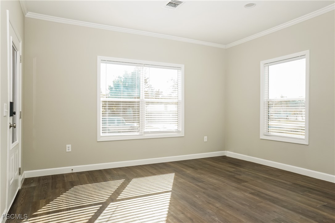 12315 Tangier Street North Port, FL 34287 - Photo 4 of 16 a view of an empty room with wooden floor and a window