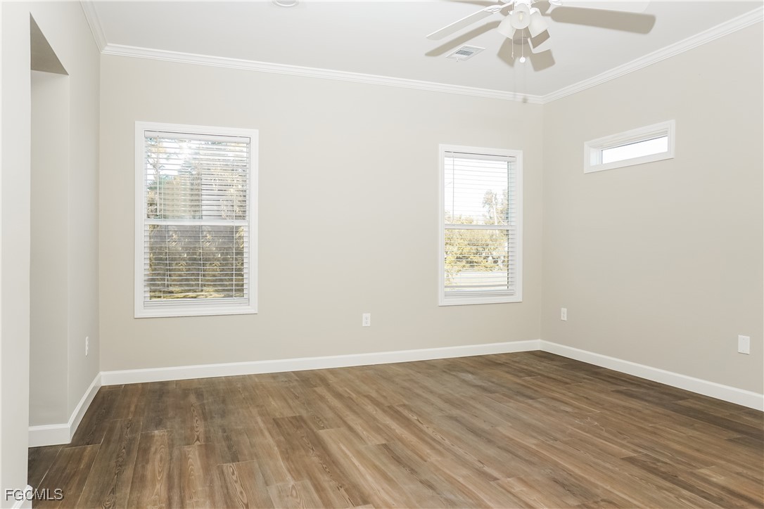 12315 Tangier Street North Port, FL 34287 - Photo 7 of 16 a view of an empty room with wooden floor and a window