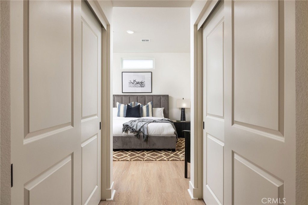 414 Main Street, Unit 310 Huntington Beach, CA 92648 - Photo 11 of 25 a bedroom with a bed and a window