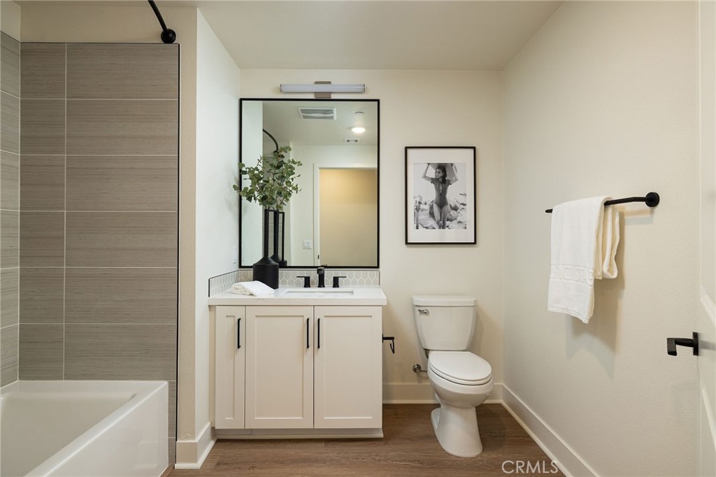 414 Main Street, Unit 310 Huntington Beach, CA 92648 - Photo 16 of 25 a bathroom with a toilet sink and mirror