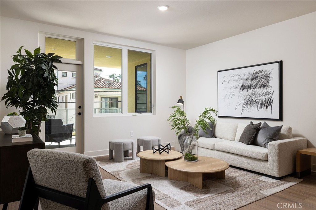 414 Main Street, Unit 310 Huntington Beach, CA 92648 - Photo 2 of 25 a living room with furniture potted plant and a large window
