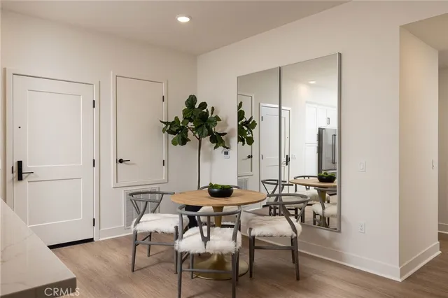 a dining room with furniture and a potted plant