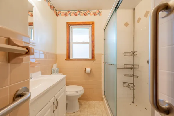 a bathroom with a toilet and a shower