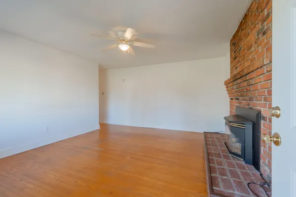 a view of fireplace with wooden floor