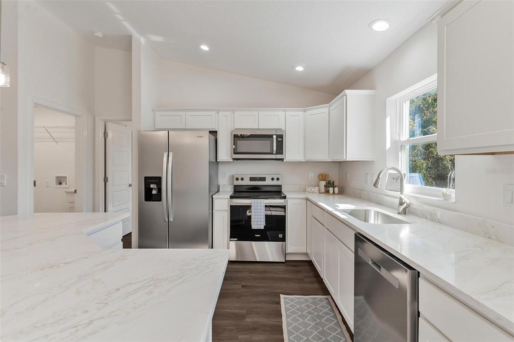2011 Edgewood Avenue Leesburg, FL 34748 - Photo 15 of 44 a kitchen with stainless steel appliances granite countertop a refrigerator and a sink