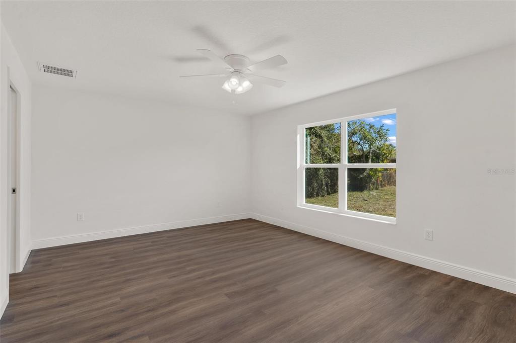 2011 Edgewood Avenue Leesburg, FL 34748 - Photo 19 of 44 a view of an empty room with wooden floor and a window