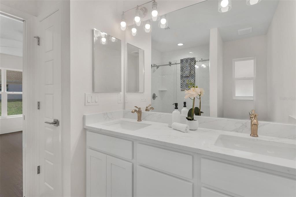 2011 Edgewood Avenue Leesburg, FL 34748 - Photo 24 of 44 a bathroom with a sink double vanity and a mirror