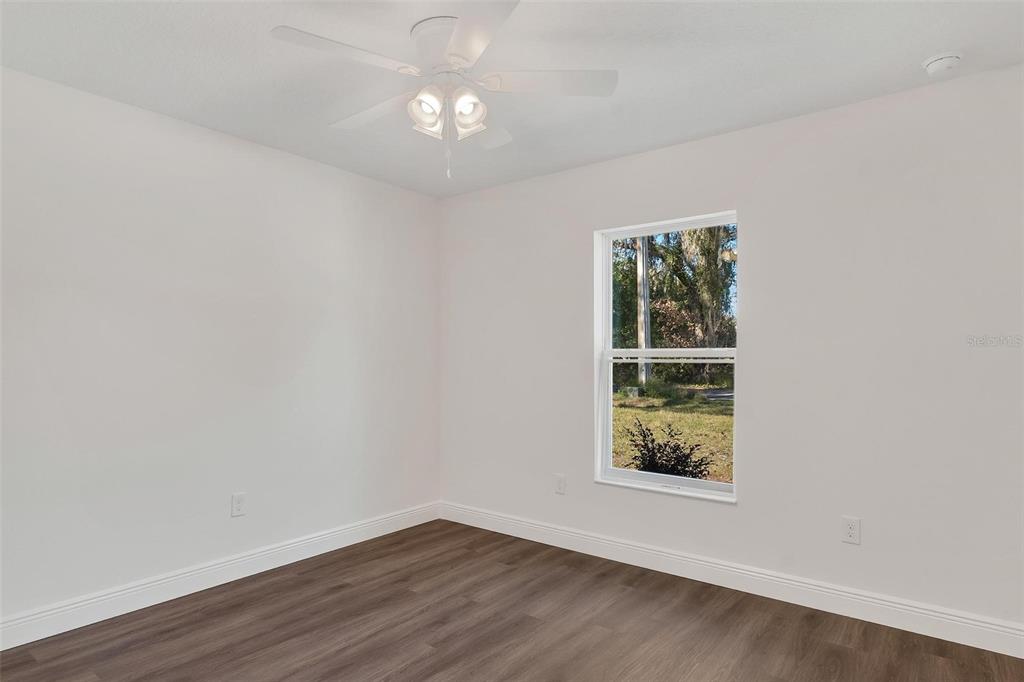 2011 Edgewood Avenue Leesburg, FL 34748 - Photo 27 of 44 an empty room with wooden floor and window