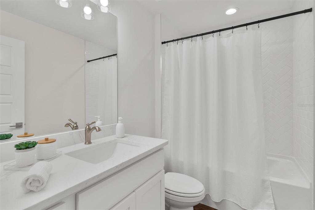 2011 Edgewood Avenue Leesburg, FL 34748 - Photo 29 of 44 a bathroom with a sink a toilet and shower curtain