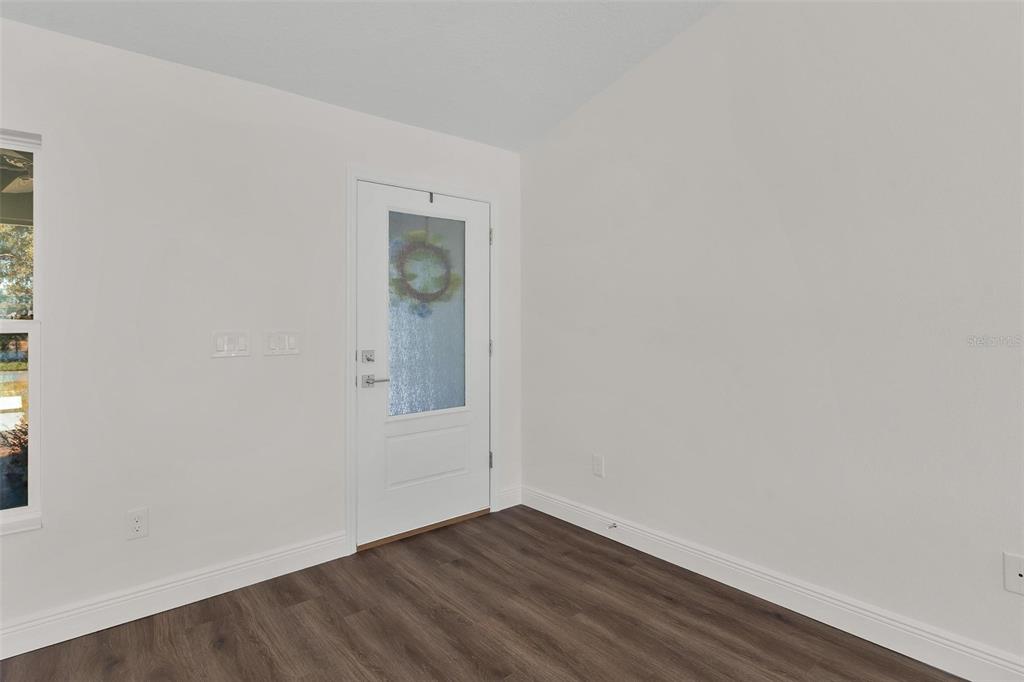 2011 Edgewood Avenue Leesburg, FL 34748 - Photo 6 of 44 a view of an empty room with wooden floor and a window