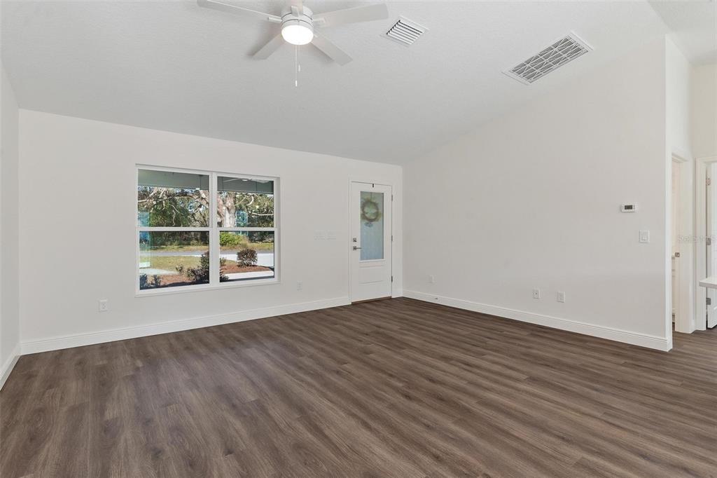 2011 Edgewood Avenue Leesburg, FL 34748 - Photo 9 of 44 an empty room with wooden floor and windows