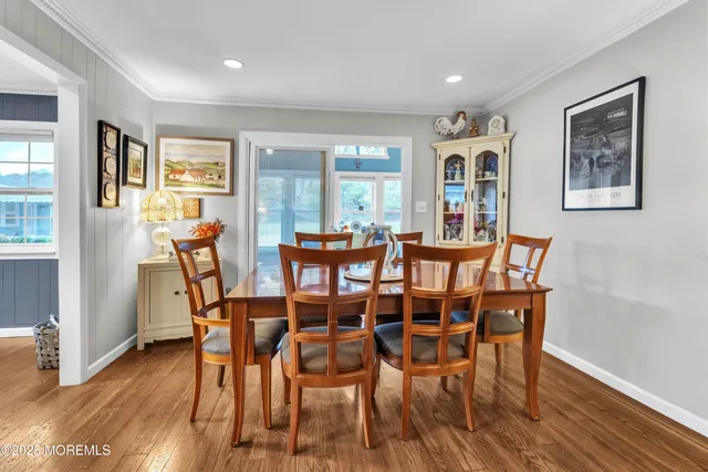 a dining room with furniture and wooden floor