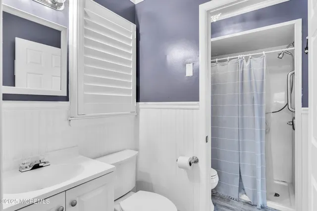 a white toilet sitting next to a bathroom sink