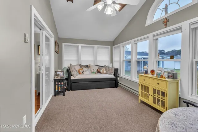 a bedroom with furniture and a large window