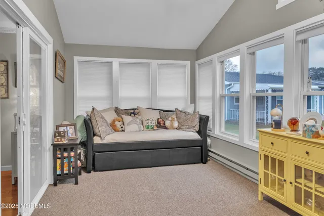 a living room with furniture and a dresser