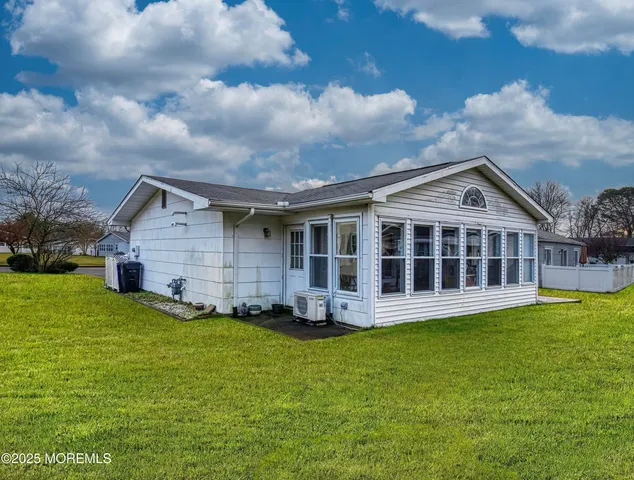 a view of a house with a yard and sitting area