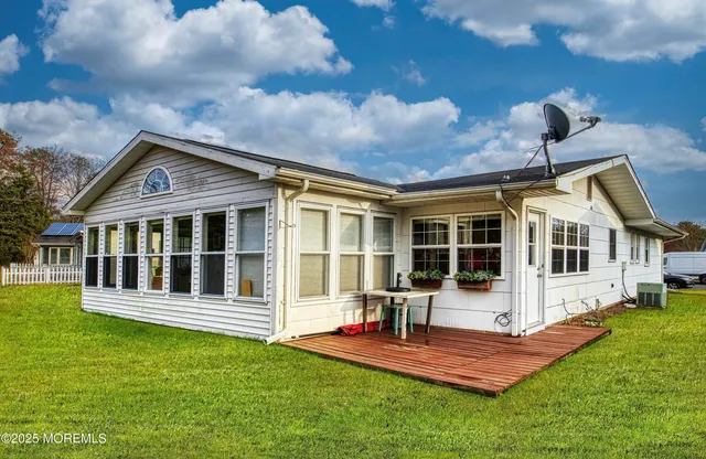 a front view of a house with a yard table and chairs