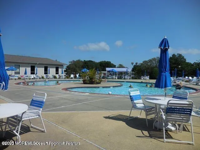 a view of a patio with table and chairs potted plants and a fountain