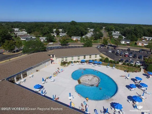 an aerial view of a house swimming pool and outdoor seating