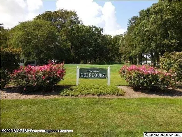 a view of a trees in front of a house with a big yard