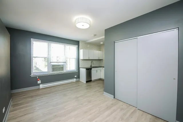 a view of a room with window and wooden floor