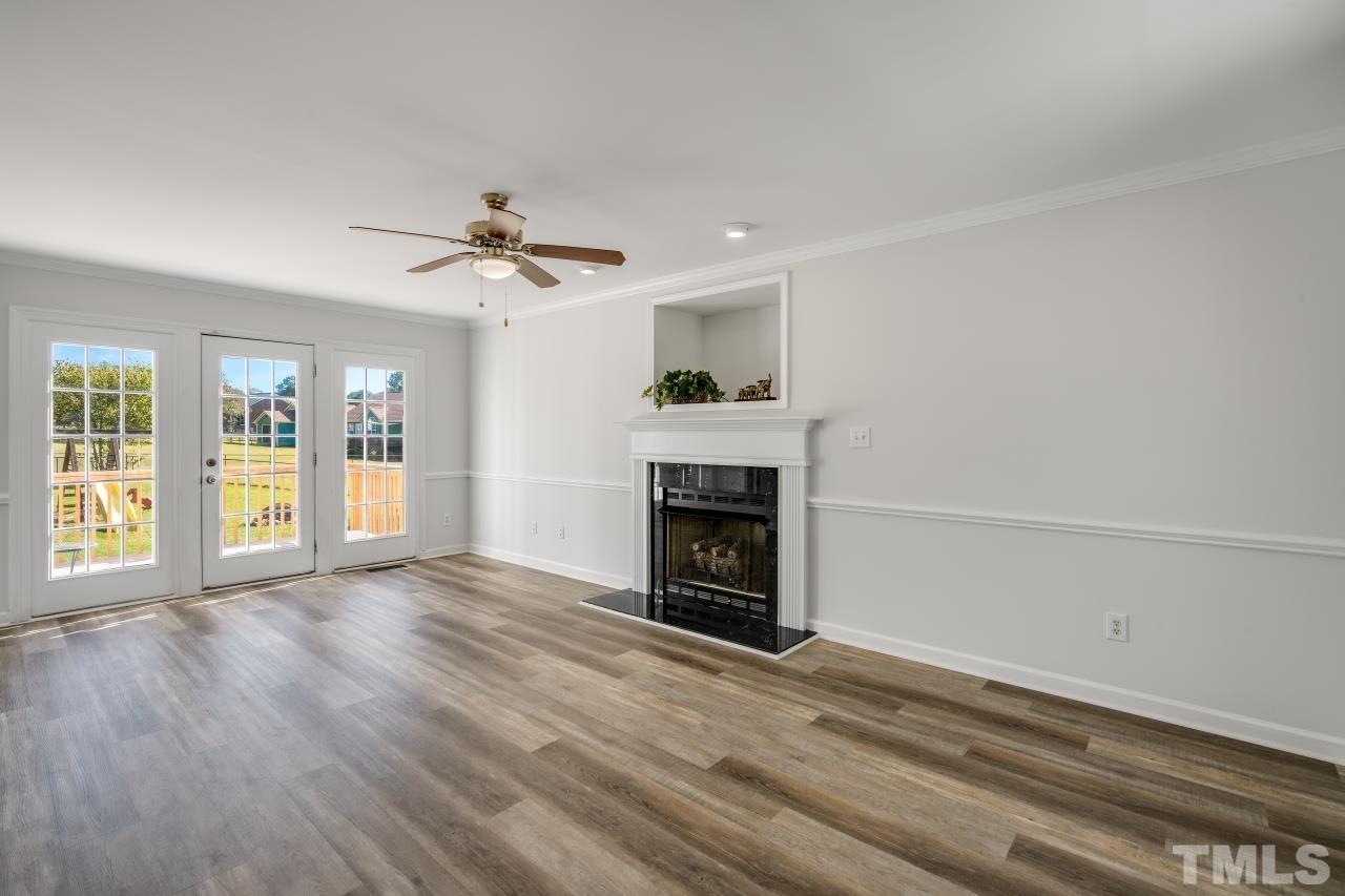704 Rudy Drive Clayton, NC 27520 - Photo 12 of 30 wooden floor fireplace and windows in an empty room