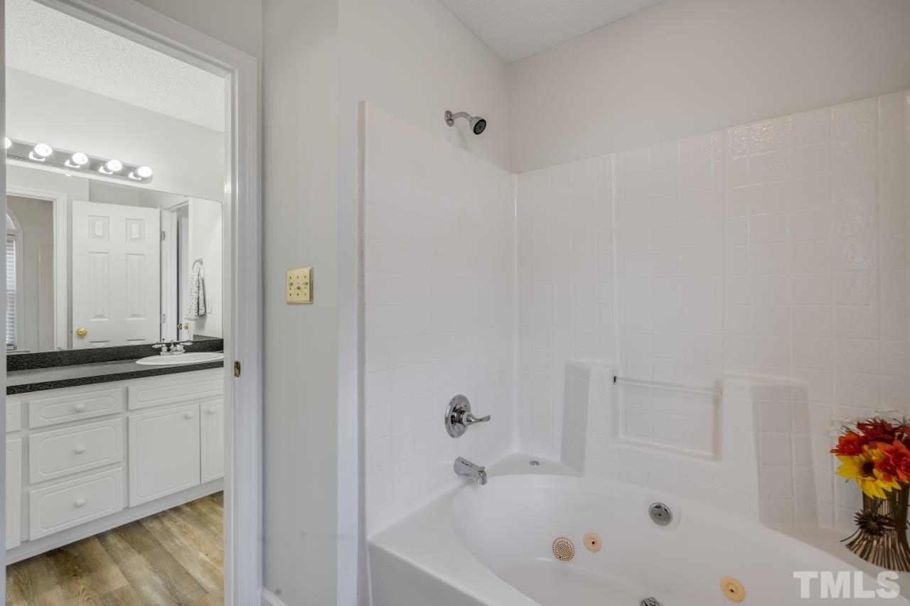 704 Rudy Drive Clayton, NC 27520 - Photo 18 of 30 a bathroom with a bathtub and a sink