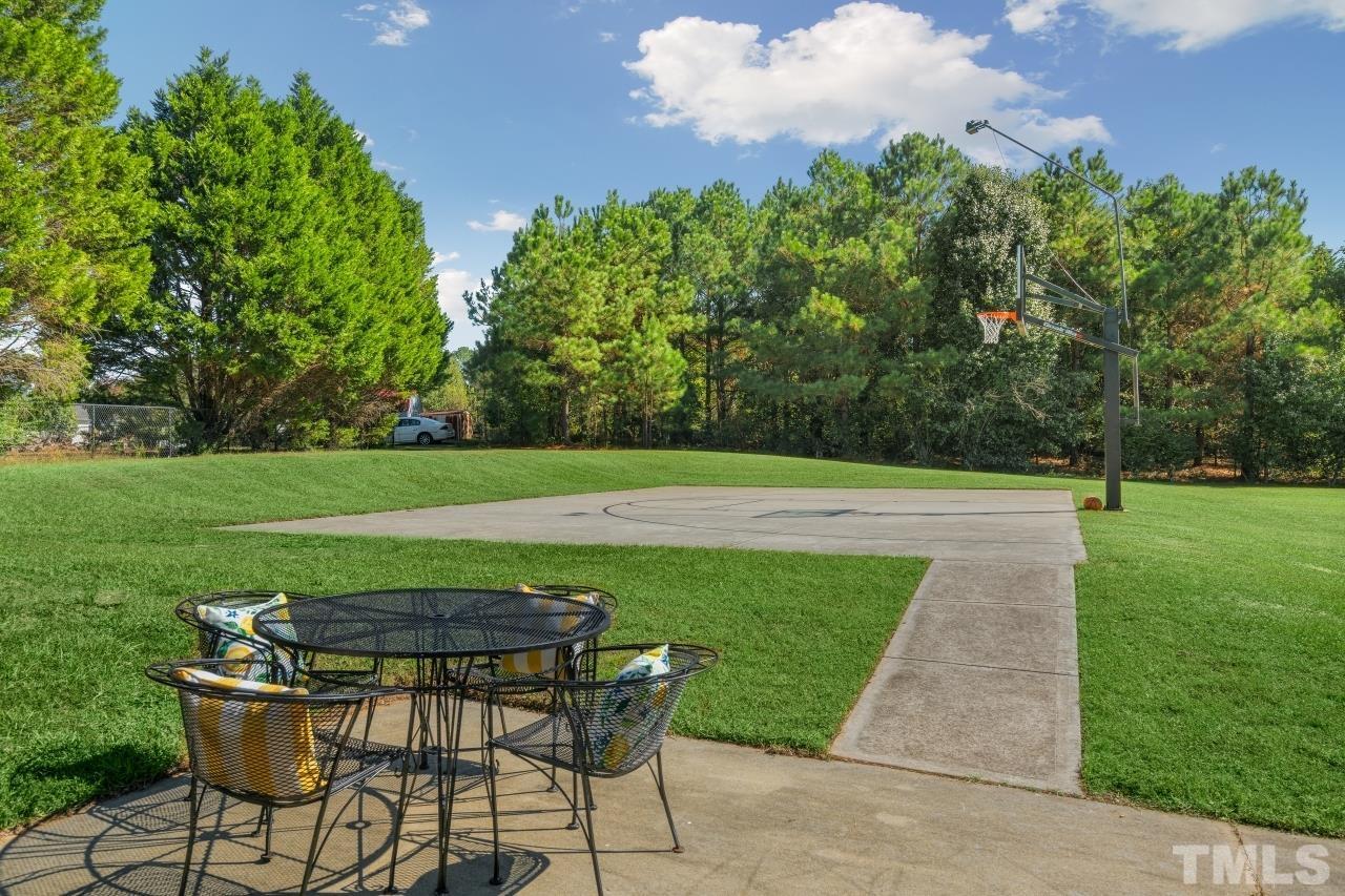704 Rudy Drive Clayton, NC 27520 - Photo 28 of 30 a view of a swimming pool and lounge chairs