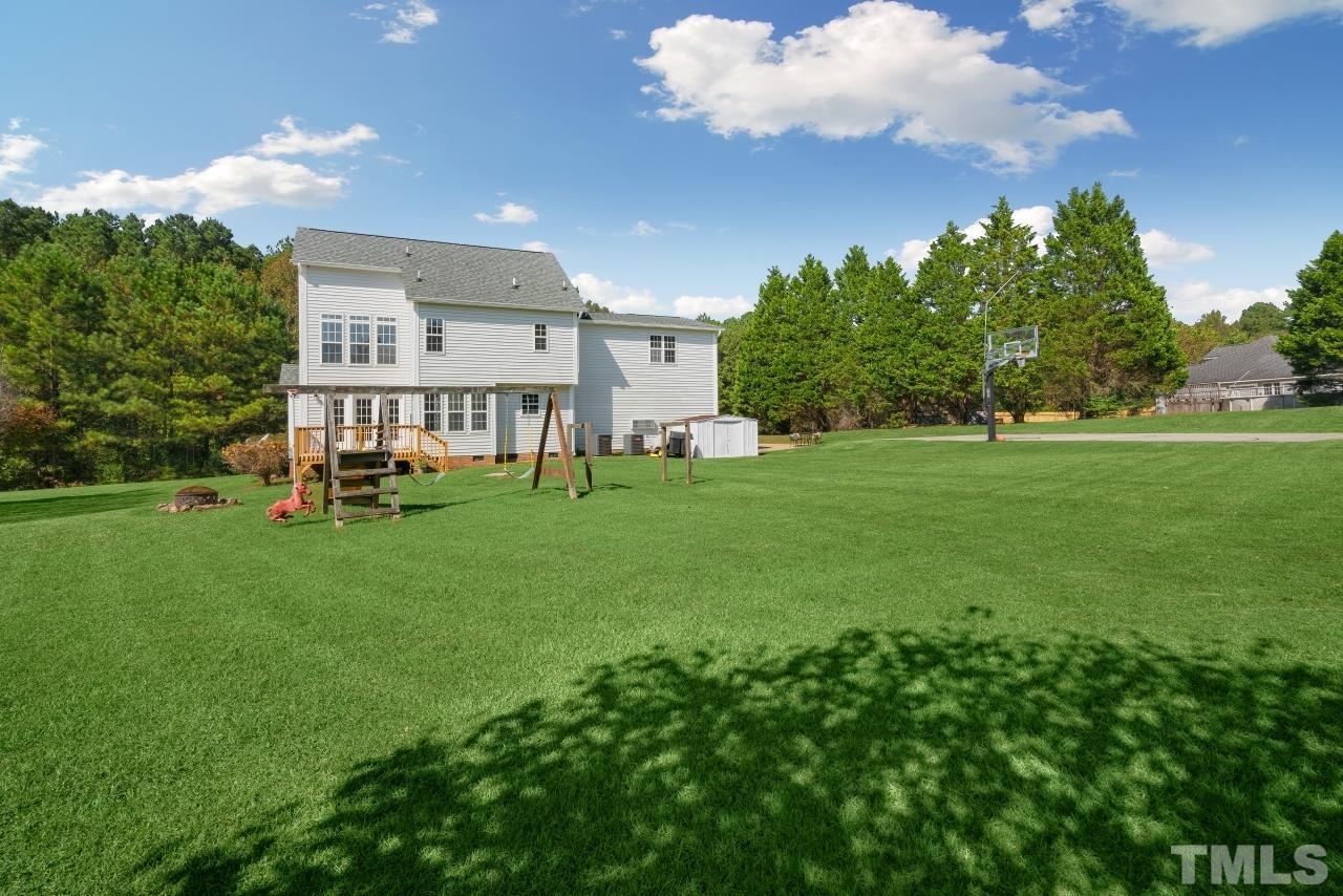 704 Rudy Drive Clayton, NC 27520 - Photo 29 of 30 a view of a house with a backyard porch and sitting area
