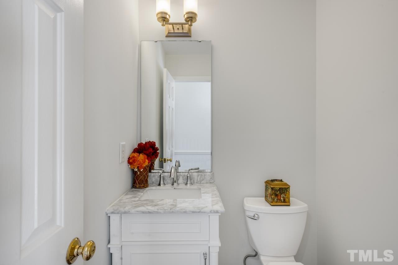 704 Rudy Drive Clayton, NC 27520 - Photo 5 of 30 a bathroom with a sink a toilet and mirror