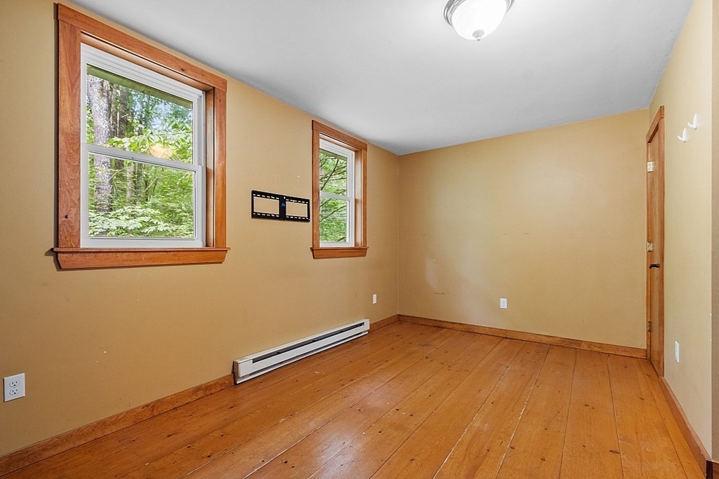 444 Old Dana Road Barre, MA 01005 - Photo 20 of 39 a view of an empty room with wooden floor and a window