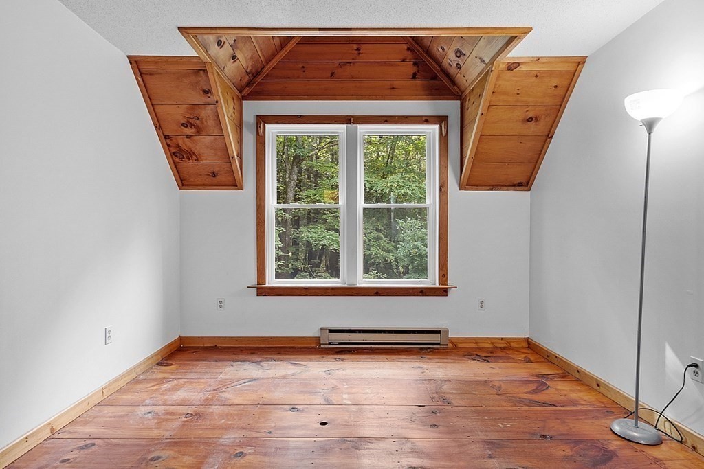 444 Old Dana Road Barre, MA 01005 - Photo 24 of 39 an empty room with wooden floor and a window