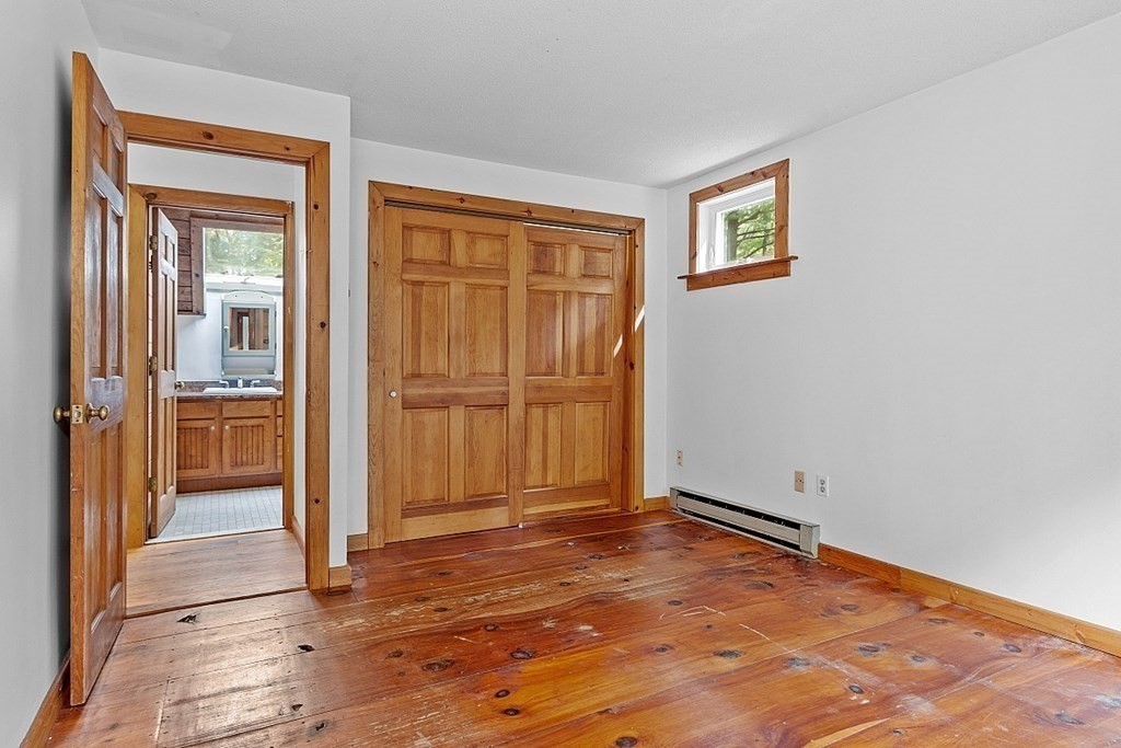444 Old Dana Road Barre, MA 01005 - Photo 25 of 39 an empty room with kitchen view and wooden floor