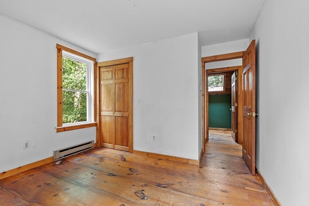 444 Old Dana Road Barre, MA 01005 - Photo 28 of 39 a view of an empty room with wooden floor and a window