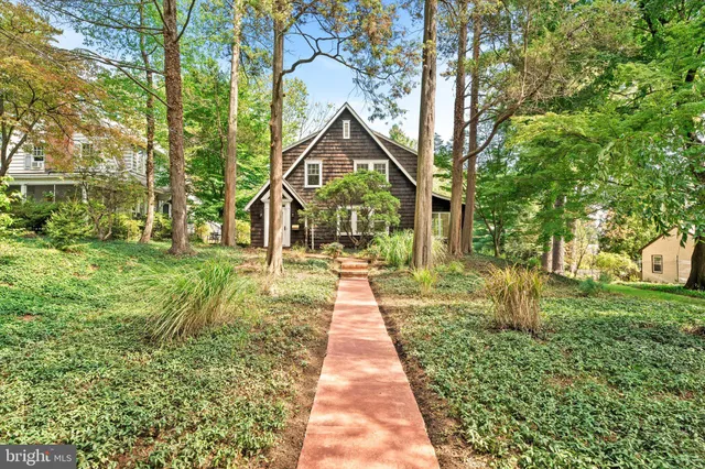 a front view of a house with a yard and fountain