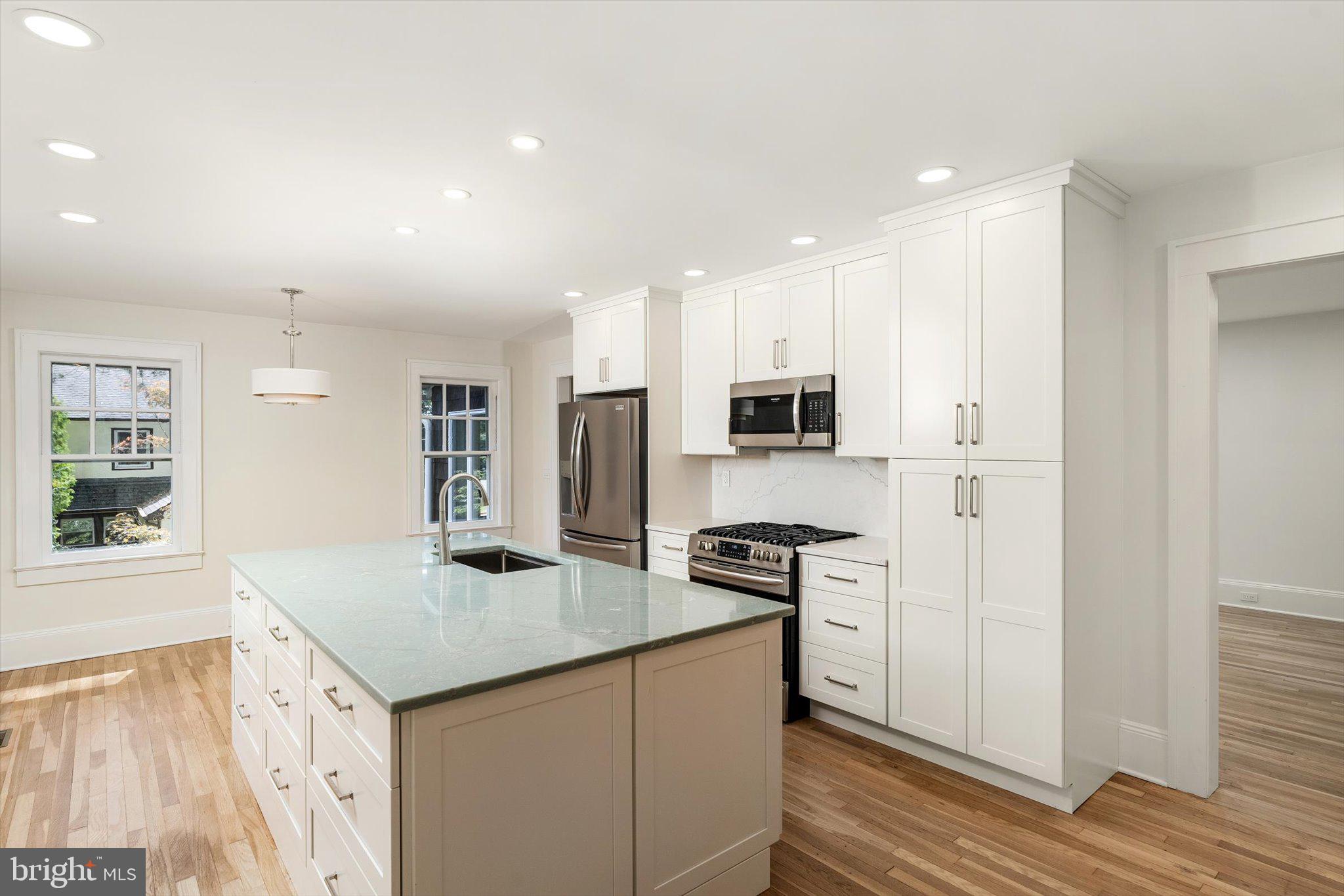 2148 Pennington Road Ewing, NJ 08638 - Photo 11 of 30 a kitchen with stainless steel appliances granite countertop a sink and a refrigerator