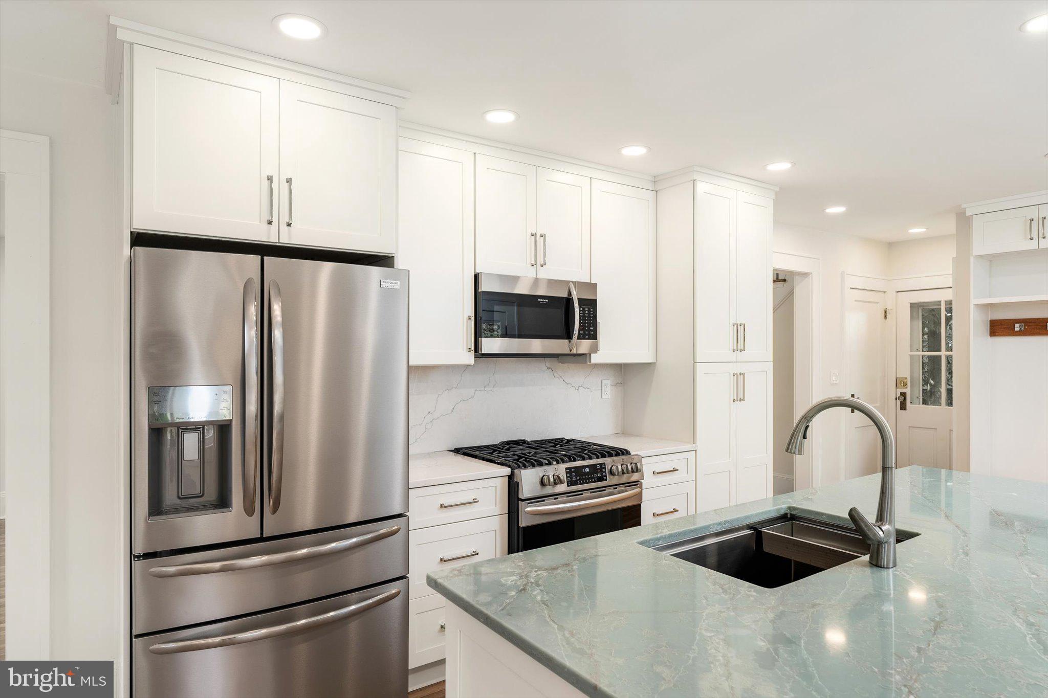2148 Pennington Road Ewing, NJ 08638 - Photo 12 of 30 a kitchen with stainless steel appliances a refrigerator stove microwave and sink