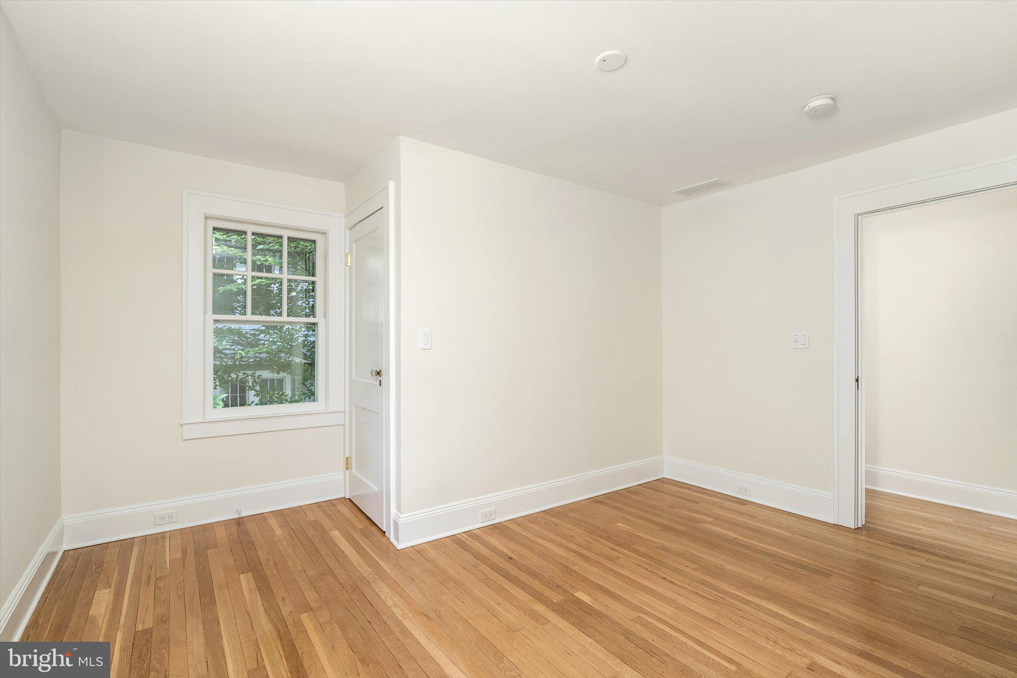 2148 Pennington Road Ewing, NJ 08638 - Photo 18 of 30 an empty room with wooden floor and windows