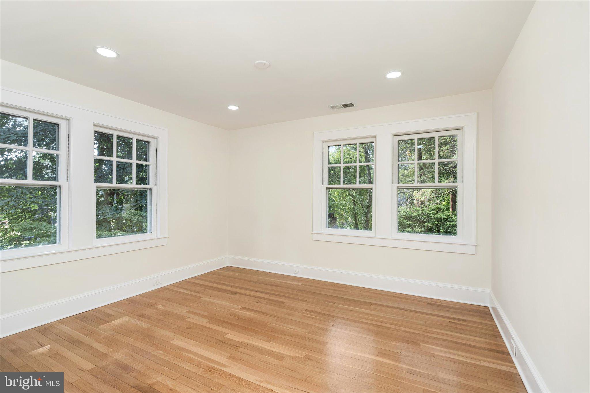 2148 Pennington Road Ewing, NJ 08638 - Photo 20 of 30 an empty room with wooden floor and windows