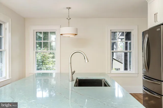 a kitchen with a refrigerator and a window