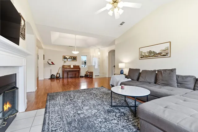 a living room with furniture a fireplace and a flat screen tv