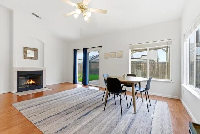 a view of a dining room with furniture and a fireplace