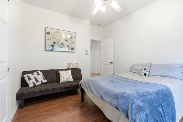 a spacious bedroom with a bed and a couch