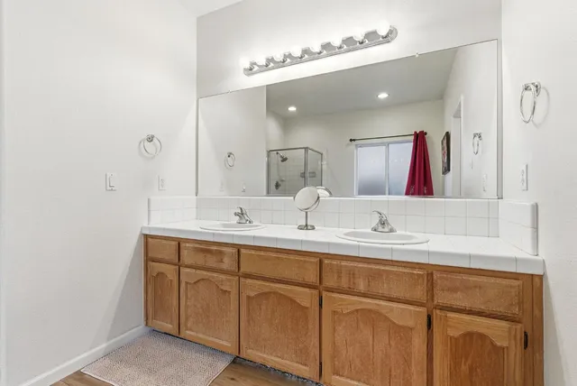 a bathroom with a double vanity sink and a mirror