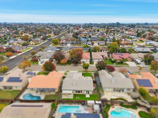 an aerial view of a house with yard