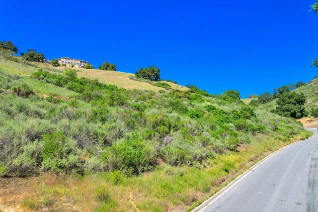 a view of a green field with an outdoor space