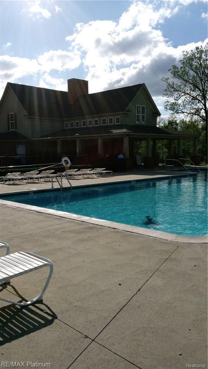 4120 Merriman Loop Howell, MI 48843 - Photo 30 of 34 club house with Pool, and Play Scape close to house