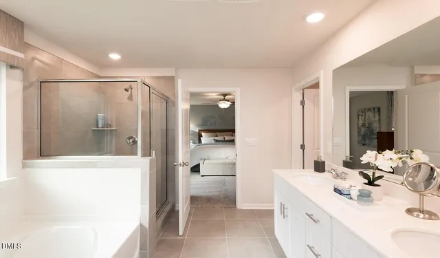 a bathroom with a bathtub shower sink and mirror